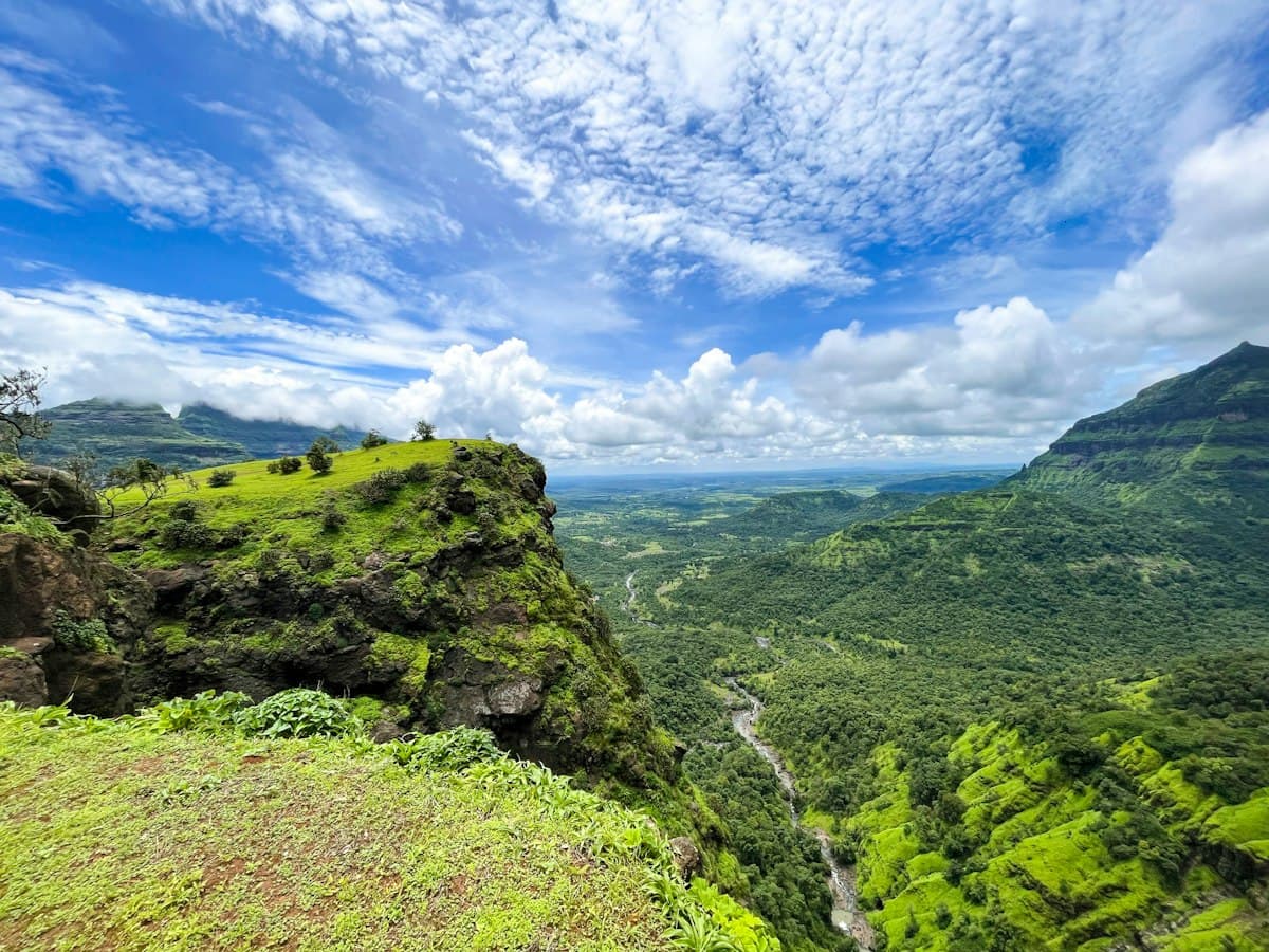 Green Sahyadri hills and forest in Maharashtra under scattered cloud