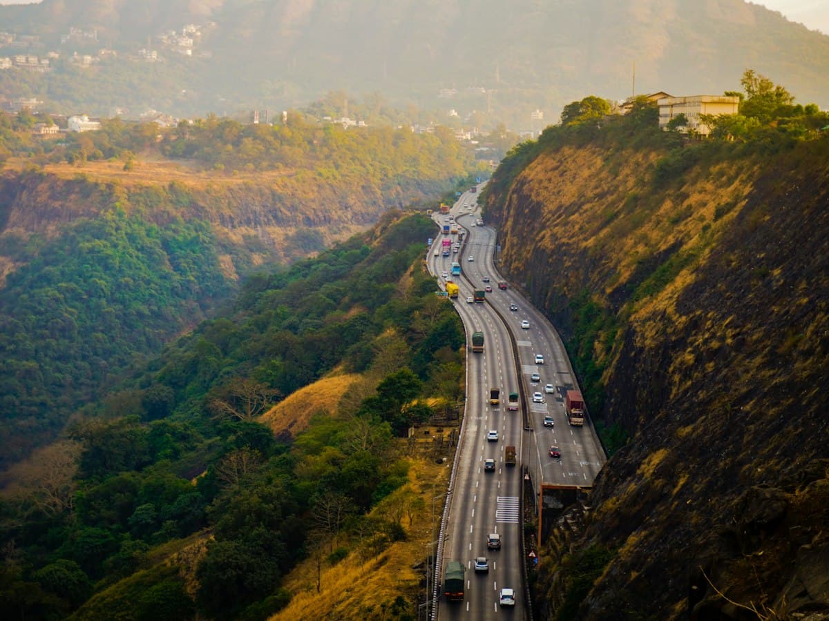 Highway running below green Sahyadri hills near Lonavala, Maharashtra
