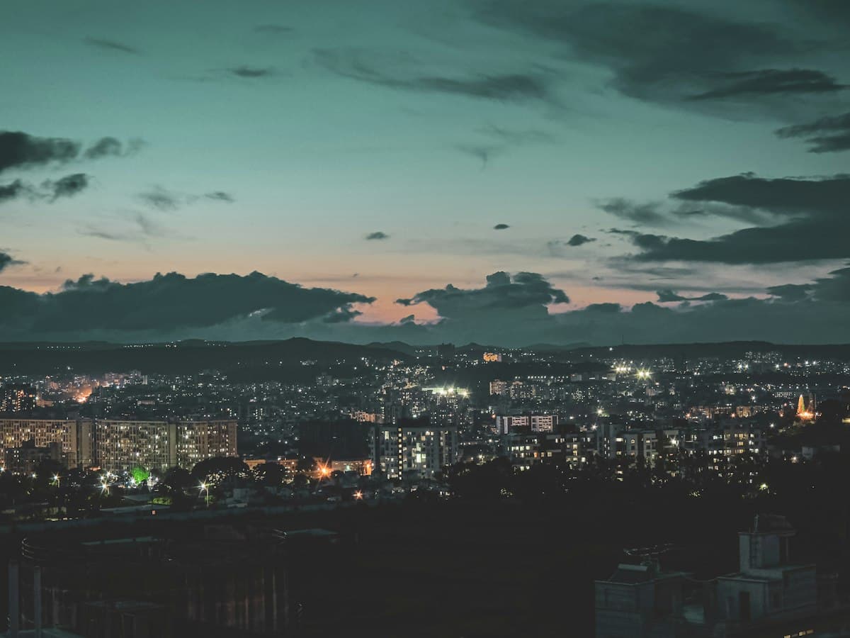 Pune city and its rooftops at sunset with hills in the distance
