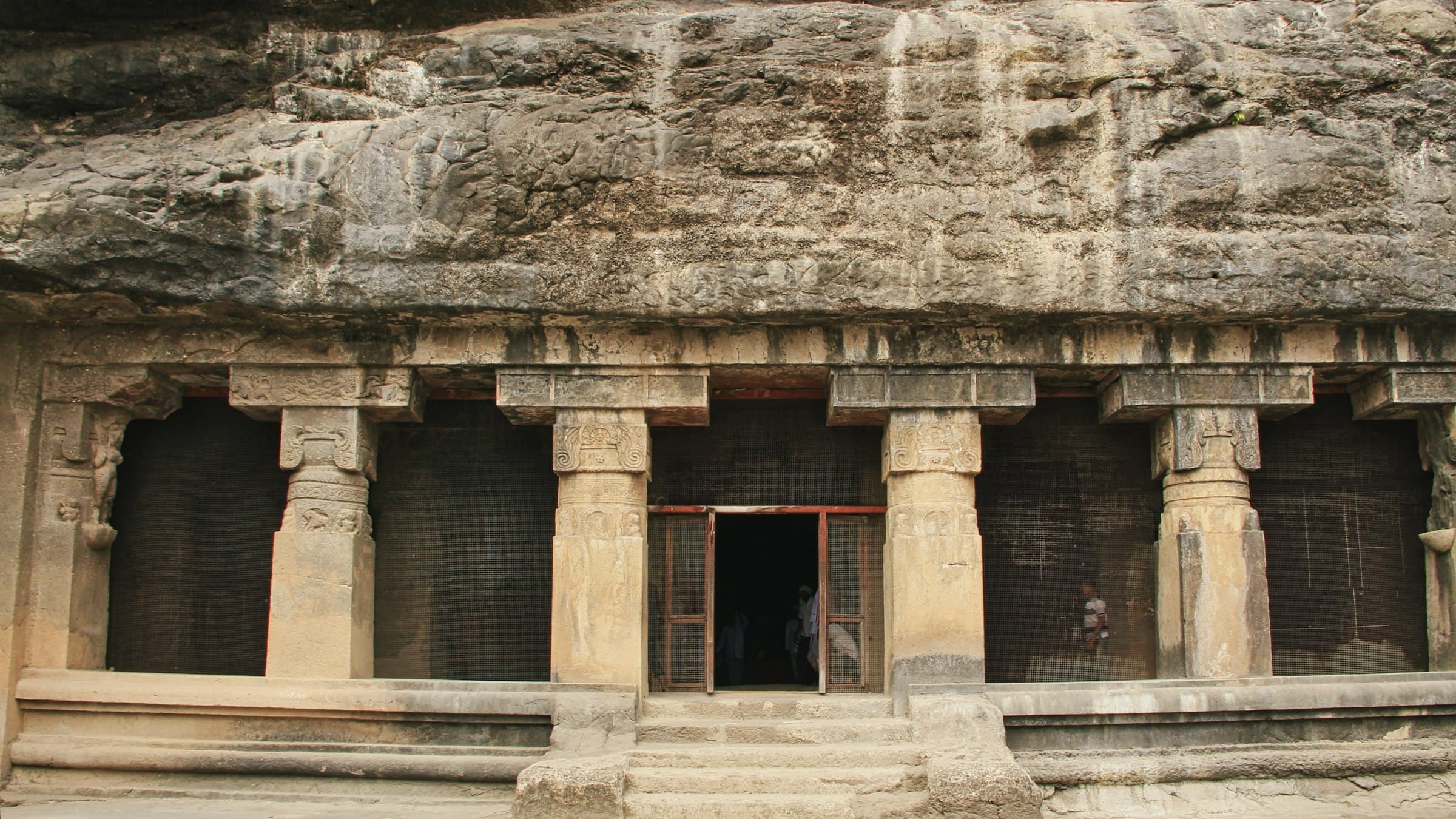 Rock-cut cave entrance with columns at the Ellora Caves, Maharashtra
