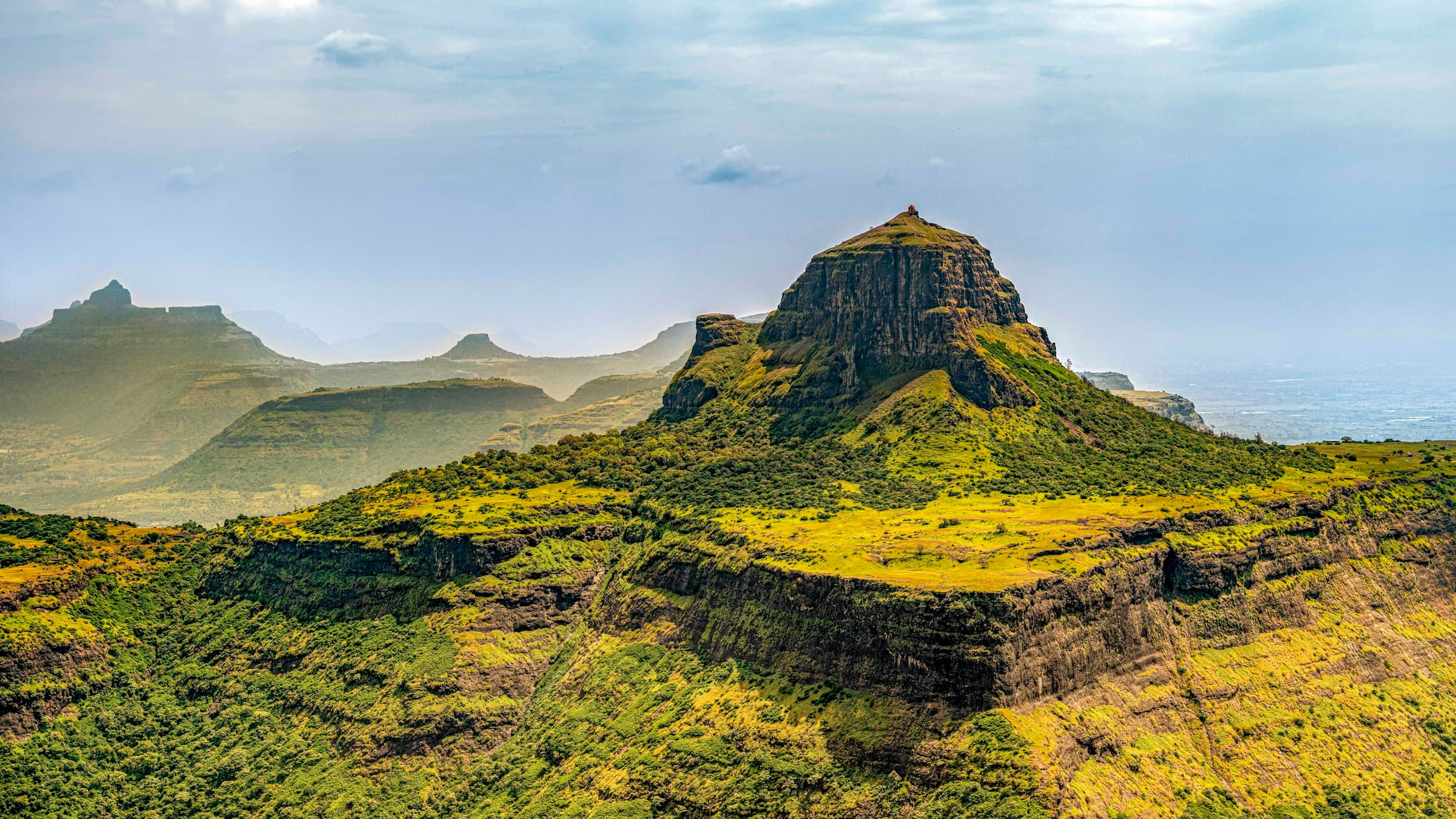 Hill with a domed summit rising above Nashik countryside, Maharashtra