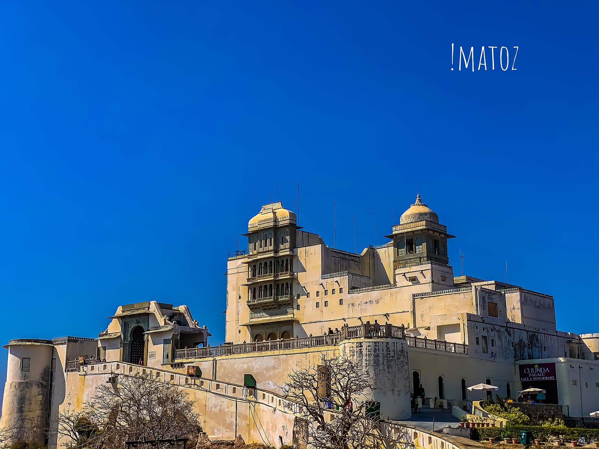 The white Monsoon Palace on its hilltop above Udaipur under a deep blue sky