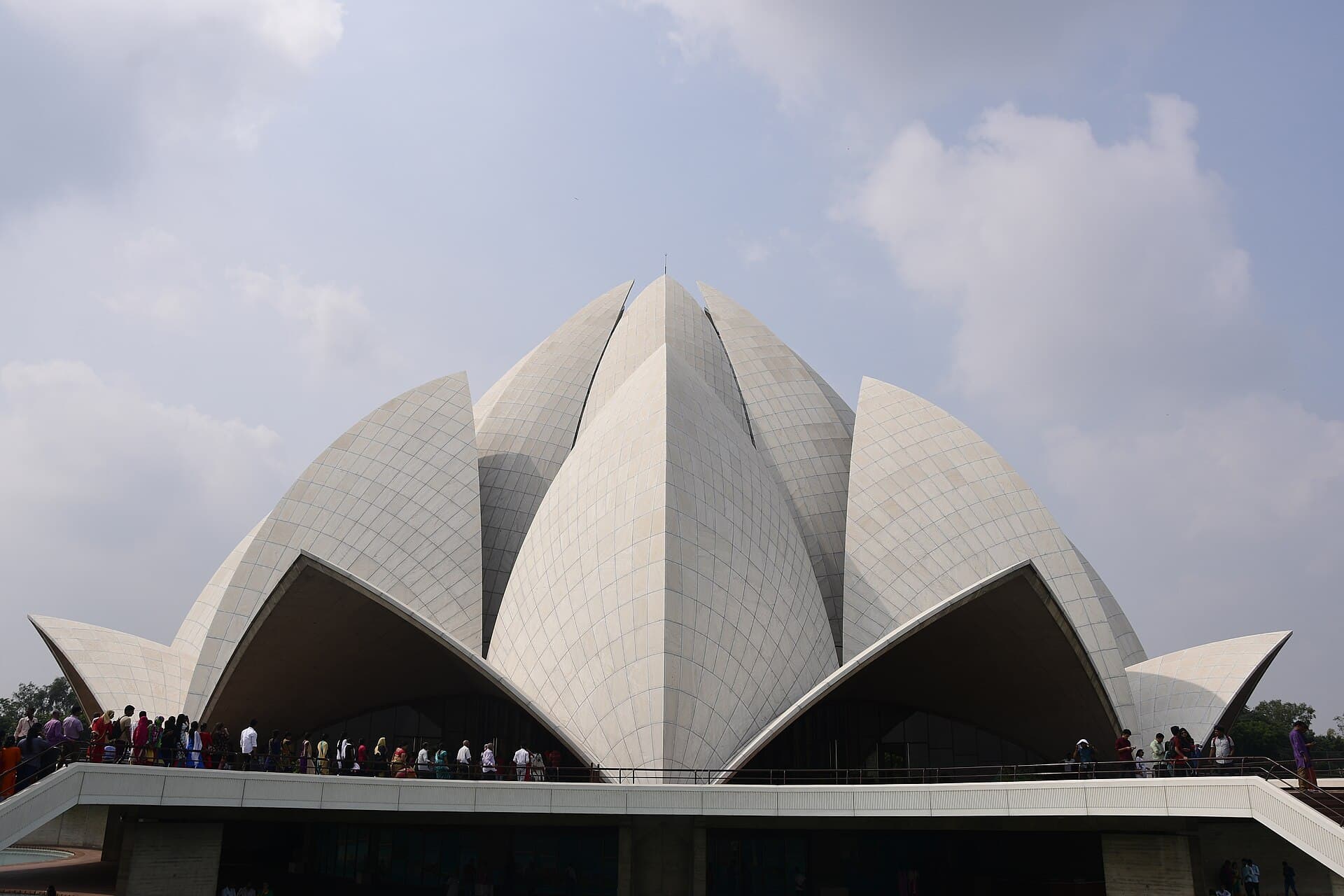 The white petal-shaped halls of the Lotus Temple, Delhi, with visitors at the base